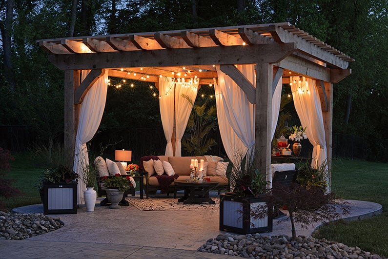 A beautiful patio featuring a pergola canopy with lights in Colorado Springs.